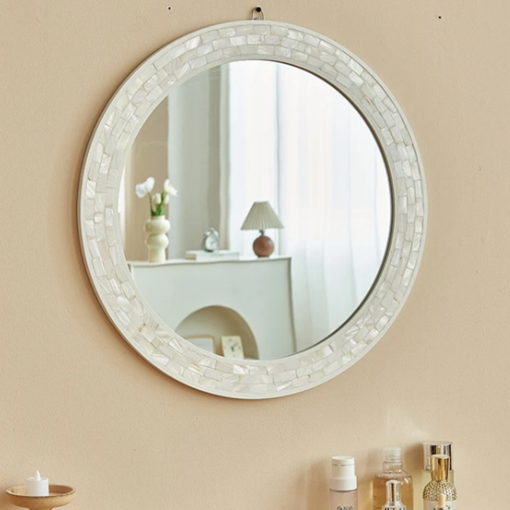 Modern round wall mirror with decorative shell frame and clear glass, white bathroom and vanity mirror for contemporary interiors