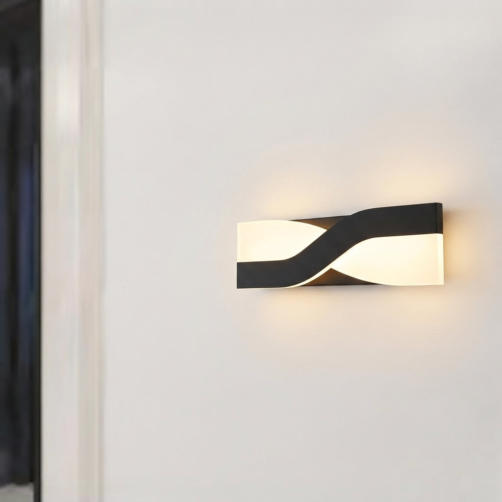 Wall sconce with head tilted for reading light beside bed