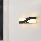 Wall sconce with head tilted for reading light beside bed