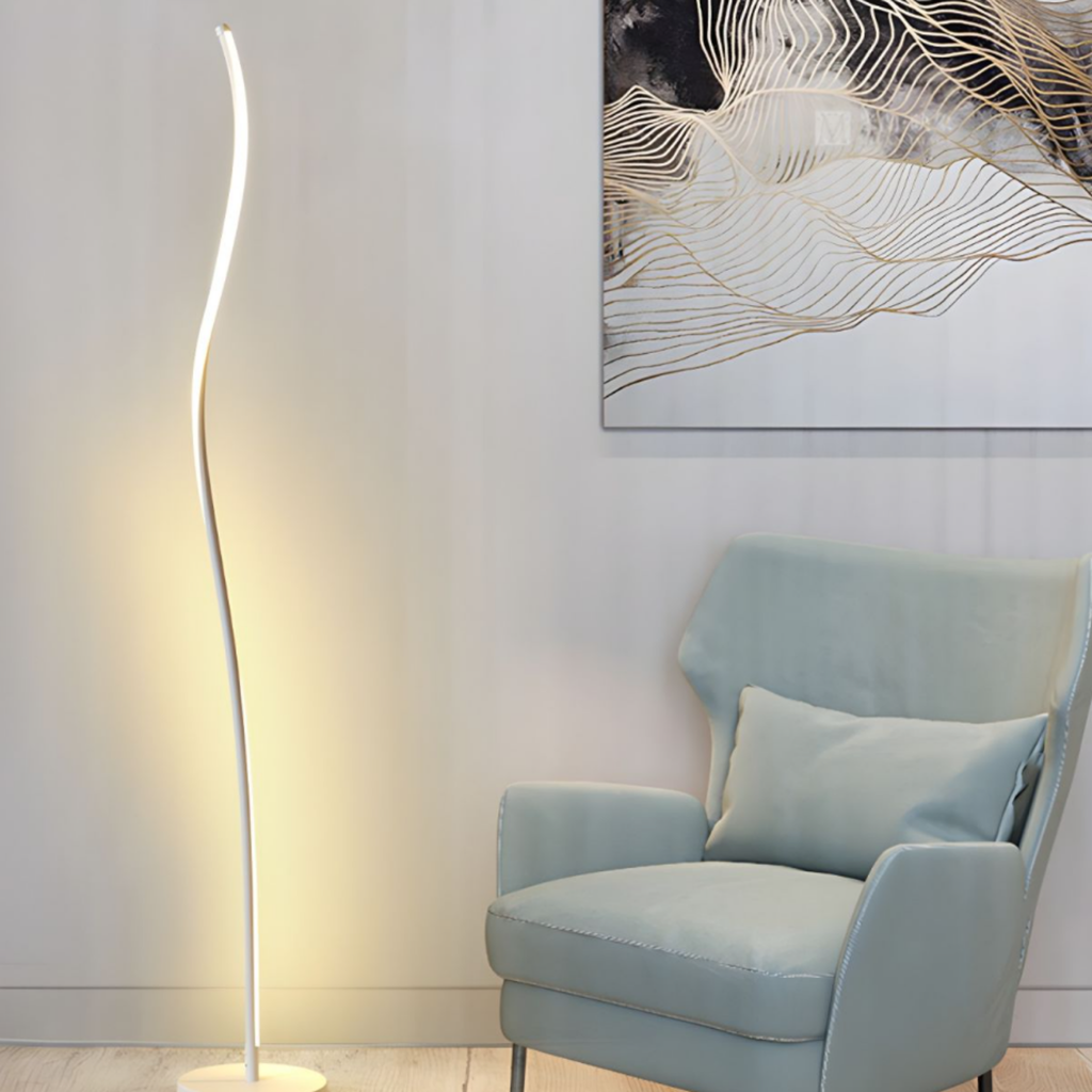 Curved LED floor lamp beside a reading chair