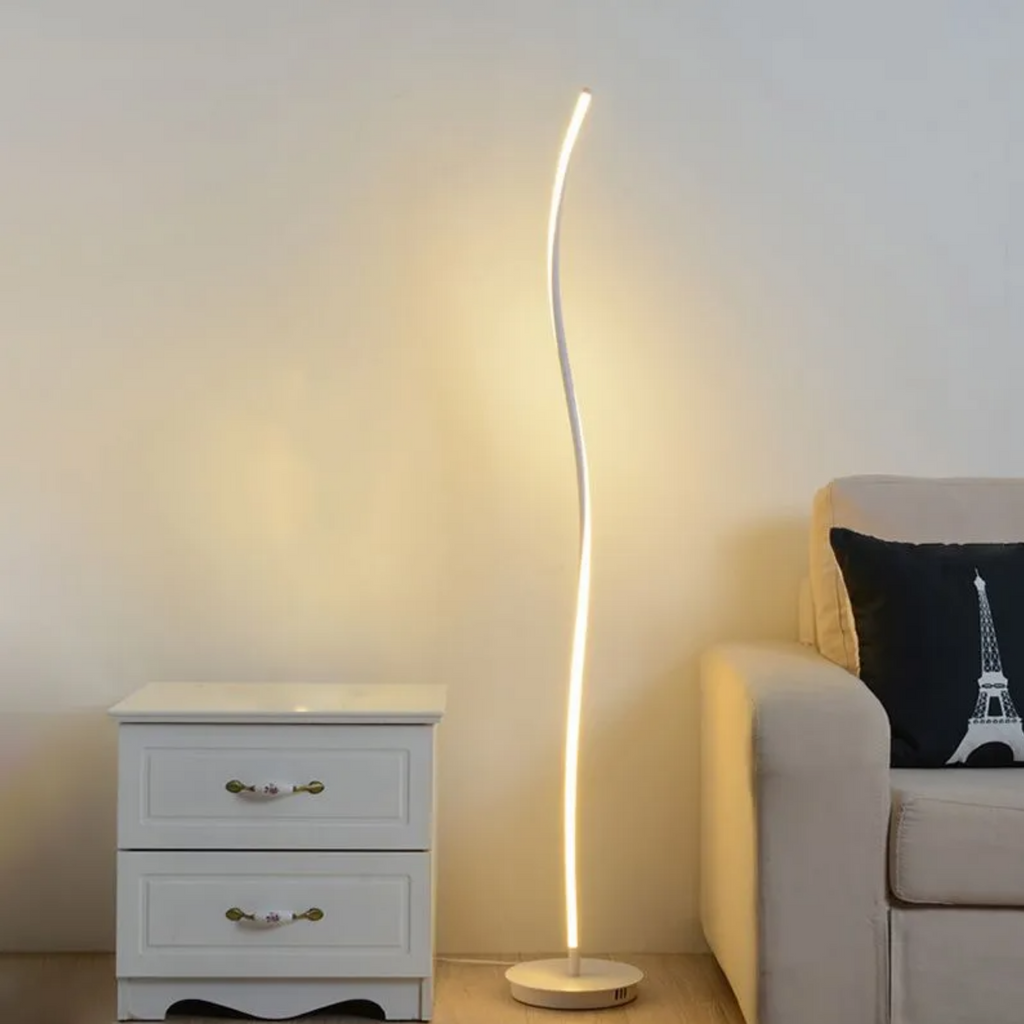 Modern curved LED floor lamp in a living room