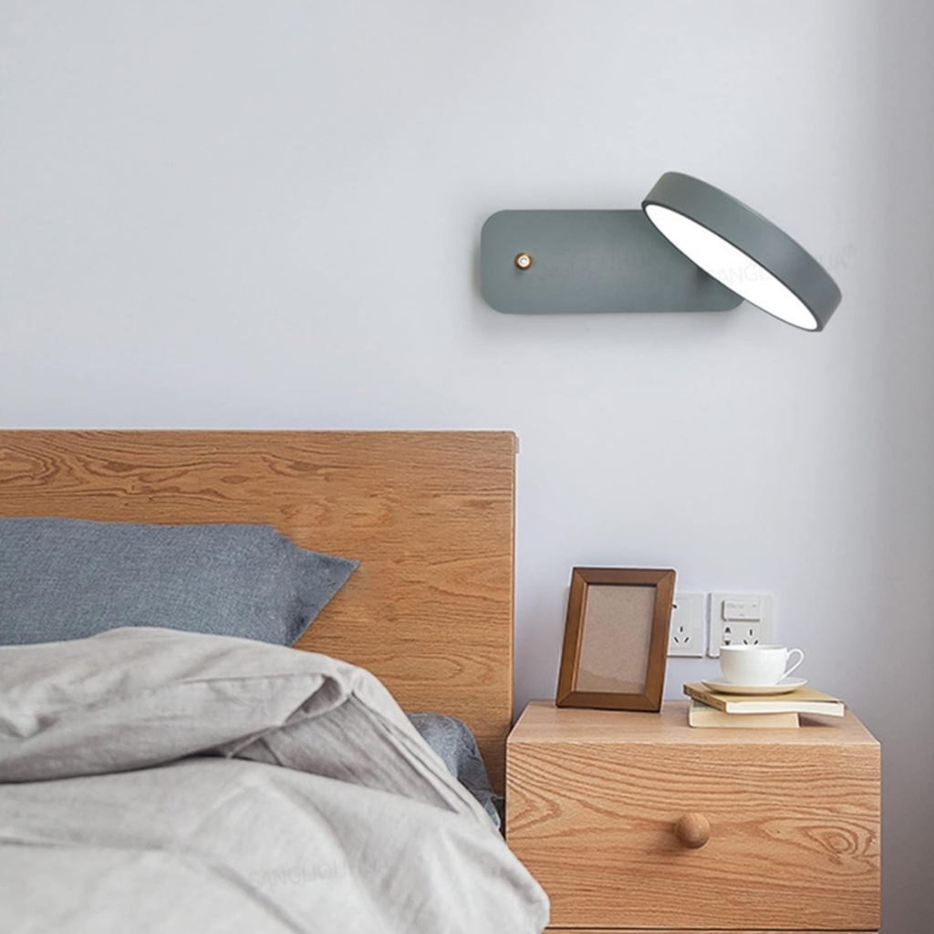 Gray modern Nordic wall light beside a bed