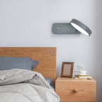 Gray modern Nordic wall light beside a bed