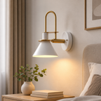 Industrial conical wall sconce in a bedroom