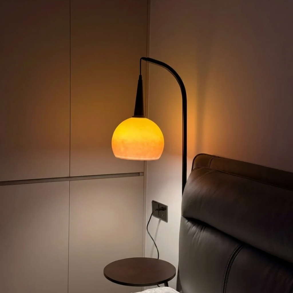 Floor lamp with built-in side table providing warm ambient lighting