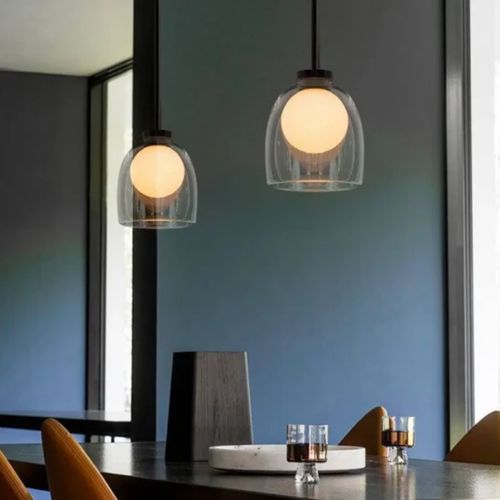 Modern clear glass bell pendant ceiling light in a dining room