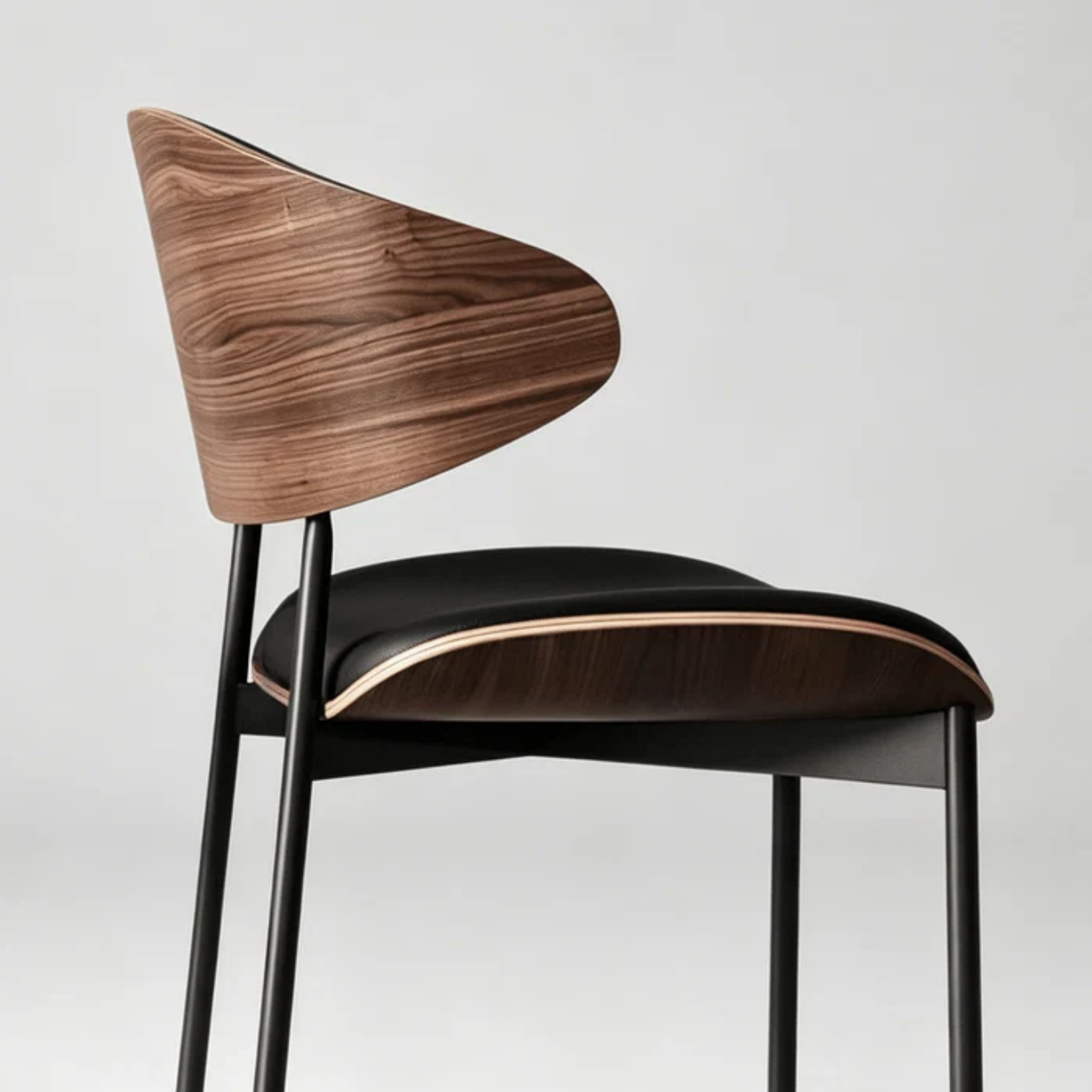 Side view of modern curved back upholstered dining chair