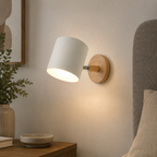 Modern cylindrical LED wall sconce in a bedroom