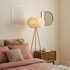 Modern feather globe floor lamp in a luxury bedroom