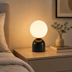 Modern glass ball table lamp on a bedroom nightstand