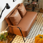 Modern leather sofa angle view with upholstered backrest and armrests