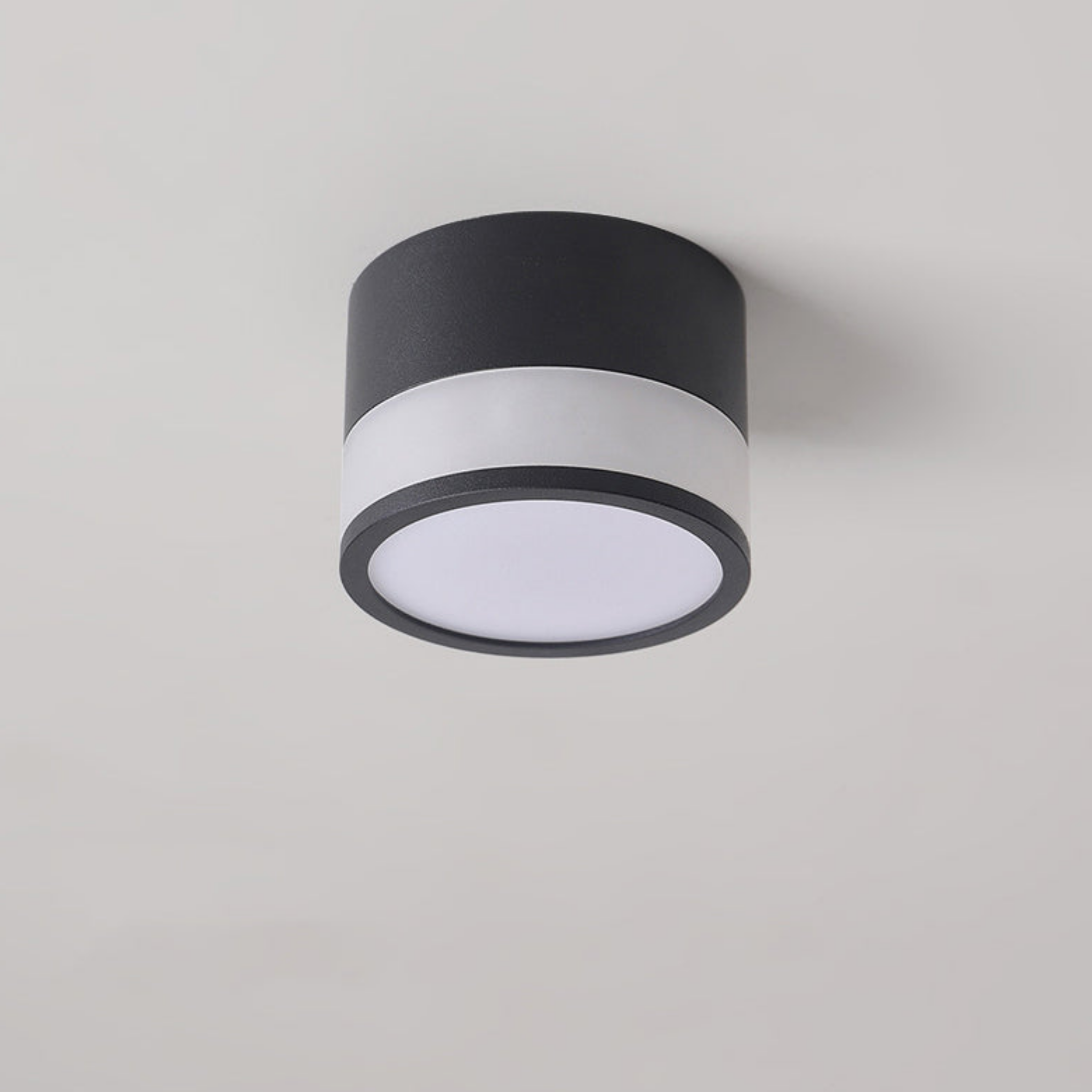 Modern black LED flush mount ceiling light turned on