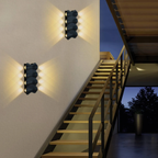Modern linear LED wall sconce beside a staircase