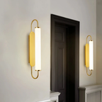 Modern luxury gold LED wall sconce in a hotel interior