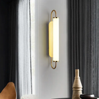 Modern luxury gold LED wall sconce in a living room
