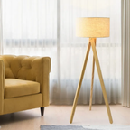 Modern minimalist solid wood tripod floor lamp in a living room