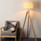Modern minimalist solid wood tripod floor lamp with warm ambient lighting