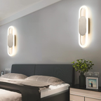 Modern oval LED wall sconce in a bedroom