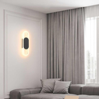 Modern oval LED wall sconce in a contemporary interior