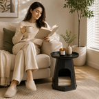 Modern round cream plastic side table with a minimalist design for use beside a sofa or bed in small living rooms and bedrooms.