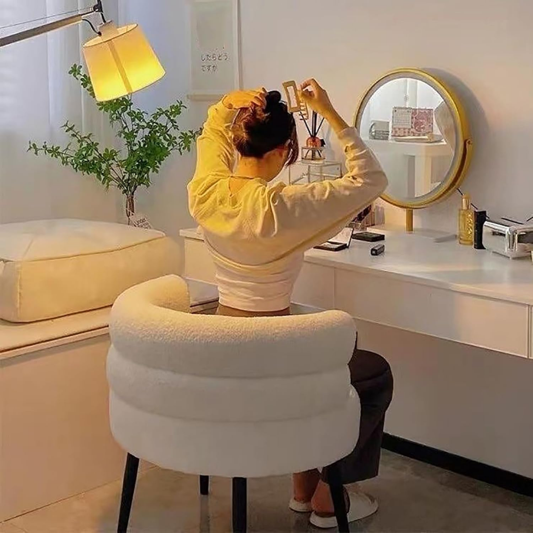 Woman sitting on the modern teddy fleece accent chair with metal legs