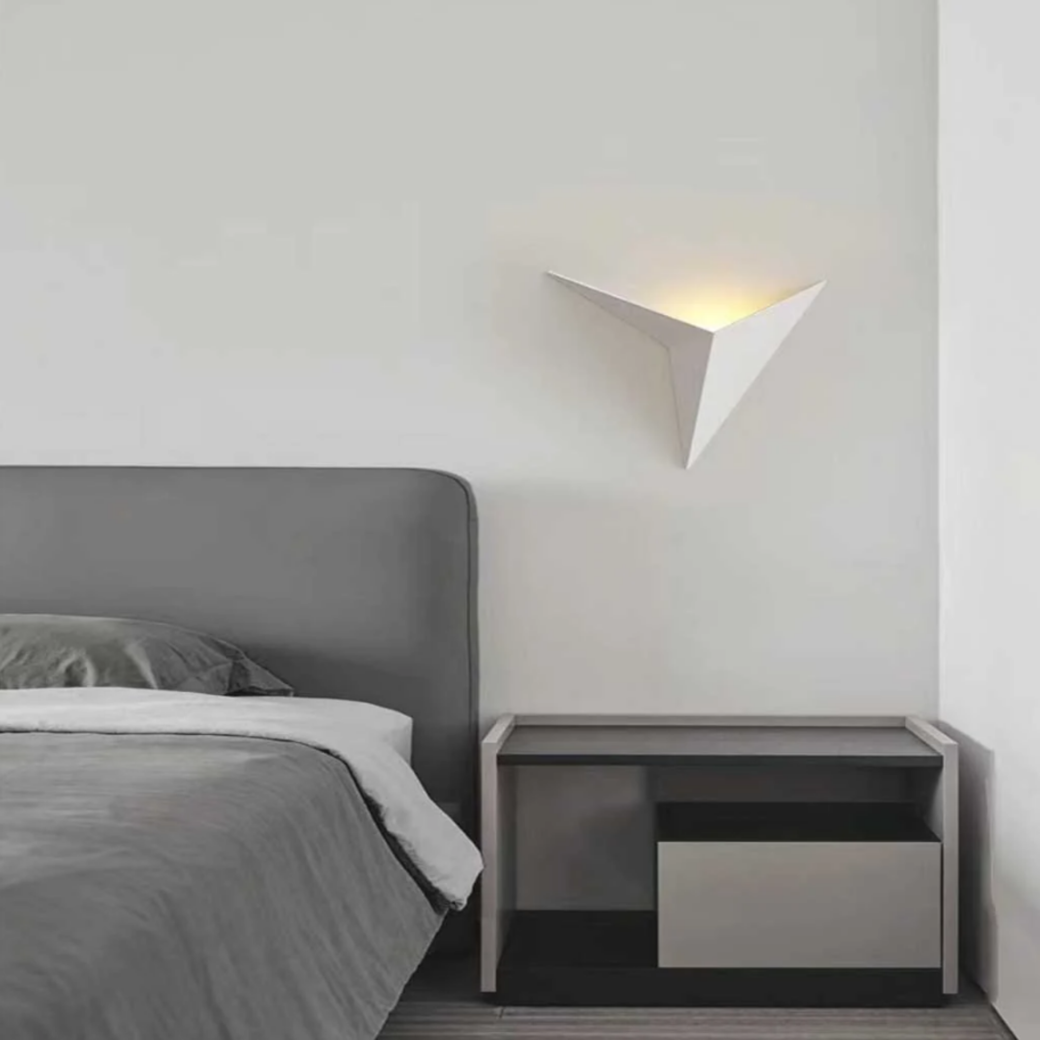 Modern triangle LED wall sconce in a bedroom