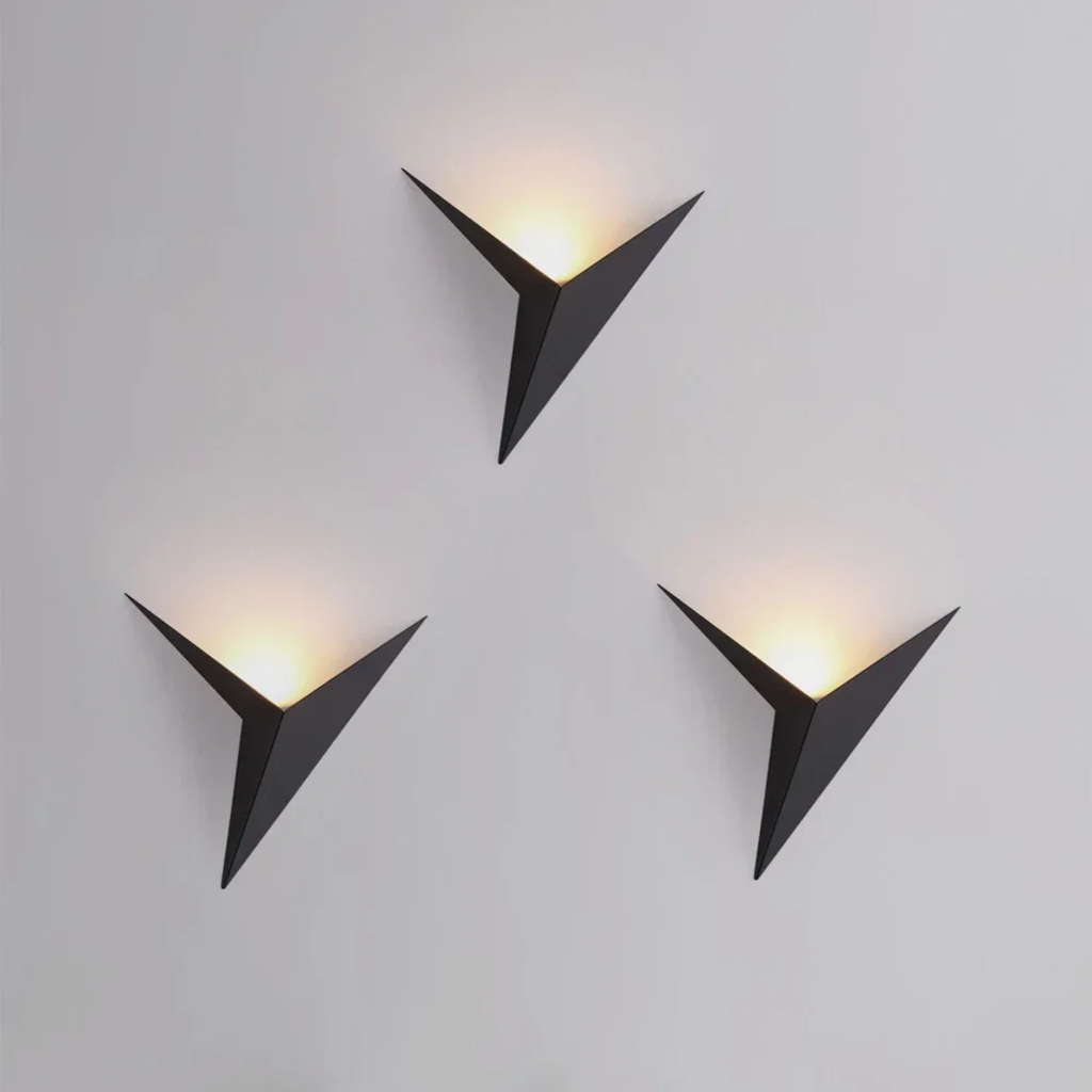 Triangle wall sconce creating a decorative light glow