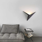 Modern triangle LED wall sconce in a living room
