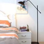 Nordic black adjustable floor lamp in a bedroom