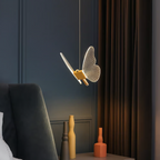 Nordic butterfly LED pendant light above a bedside table