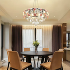 Pink rose crystal glass pendant light above a dining table