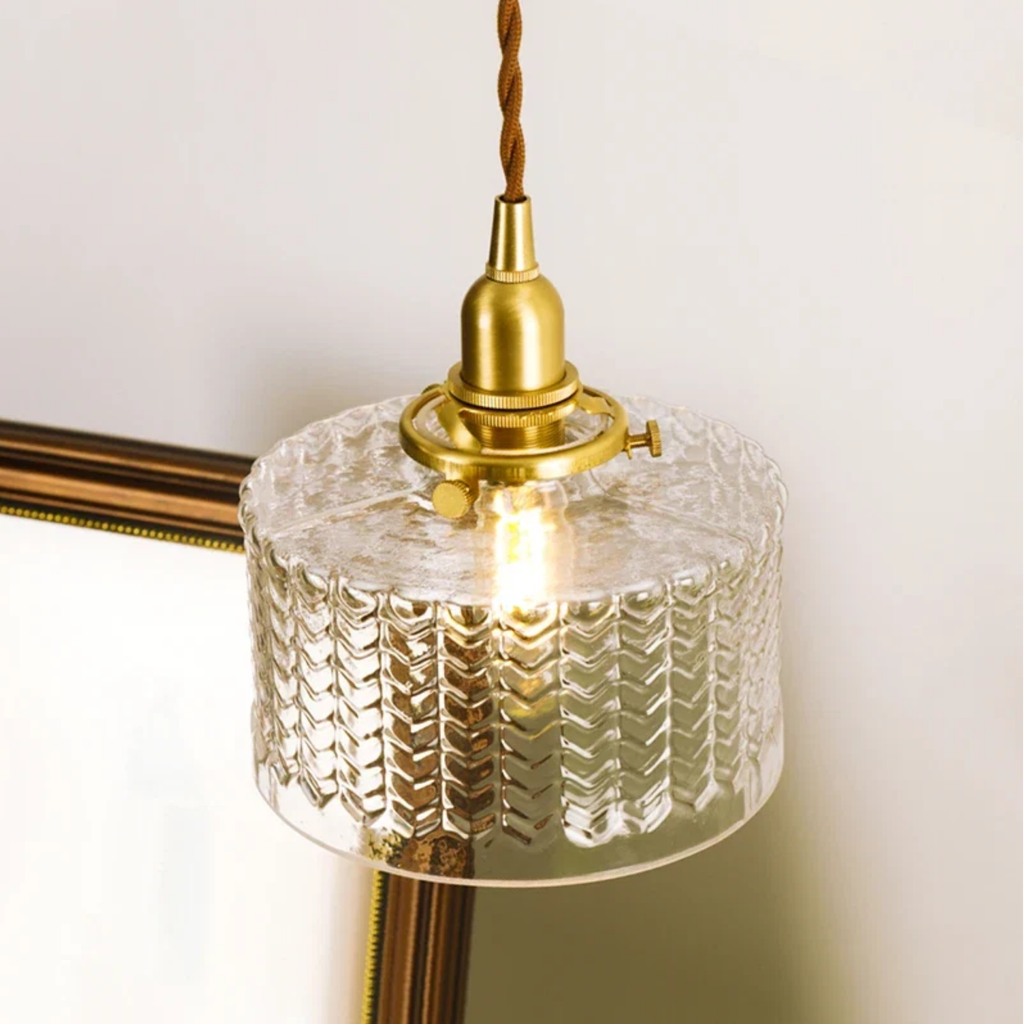 Close-up of round glass shade on pendant light