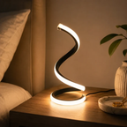 Snake shape LED table lamp on bedside table