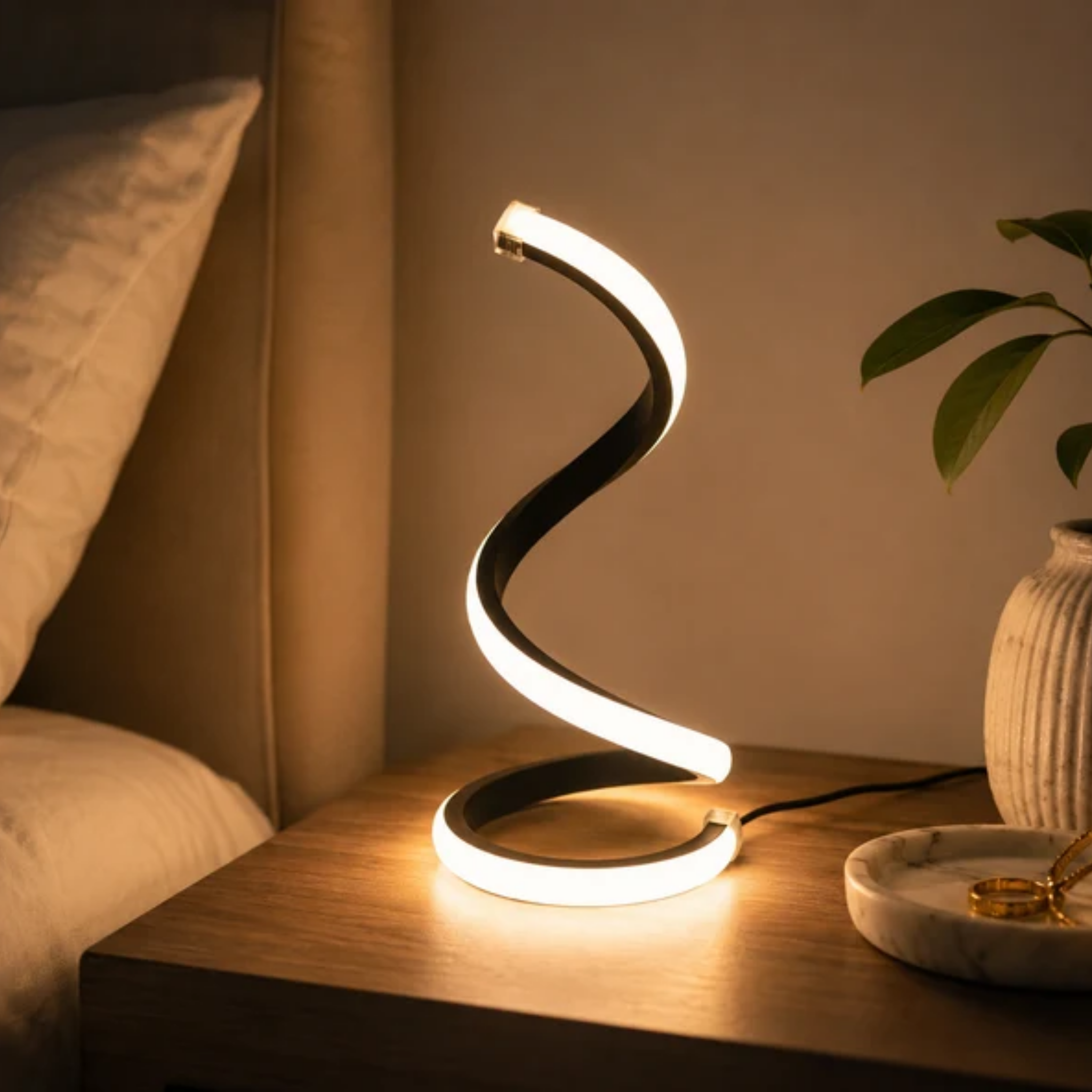 Snake shape LED table lamp on bedside table