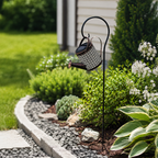 Solar watering kettle lamp in a backyard landscape