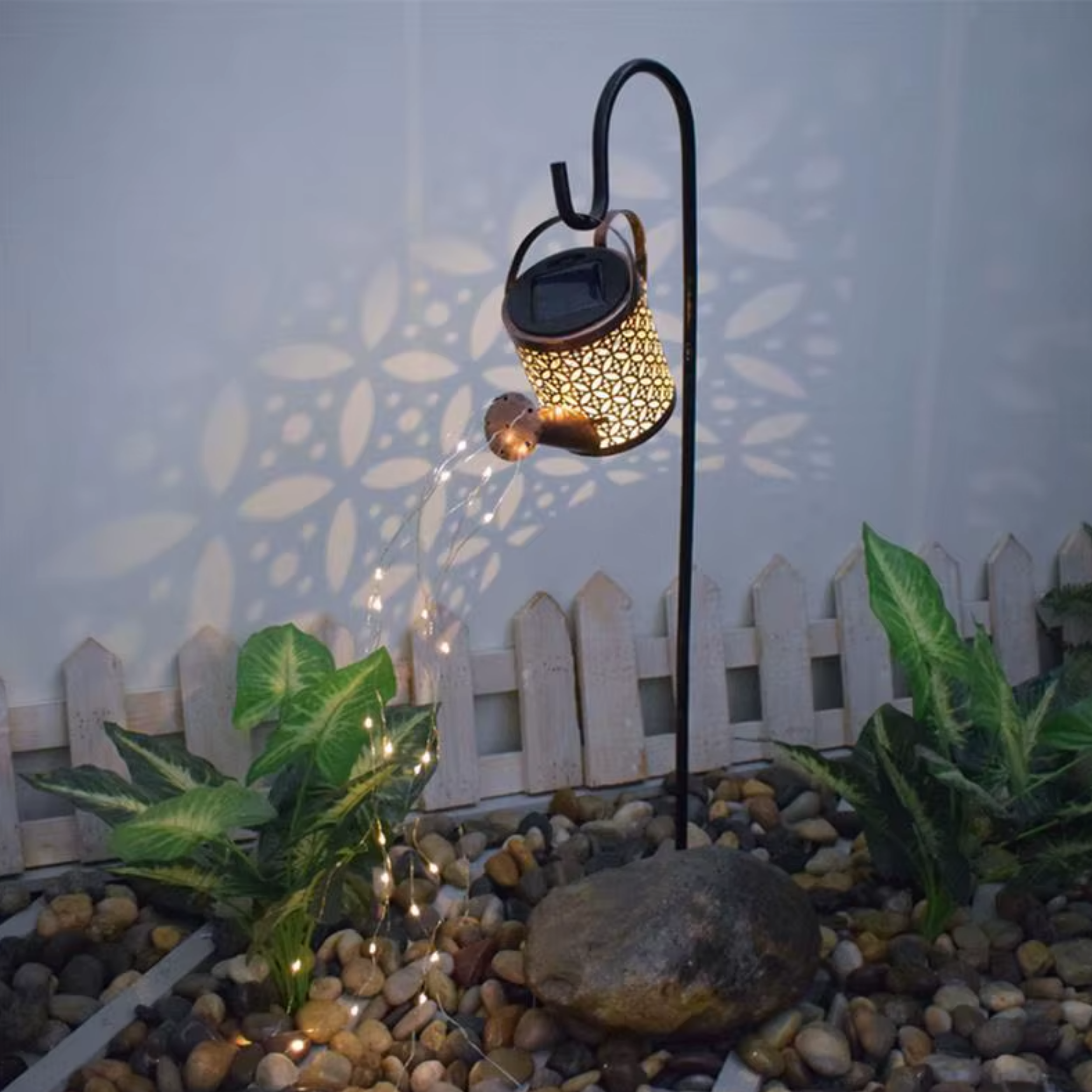 Solar watering kettle lamp with warm evening glow